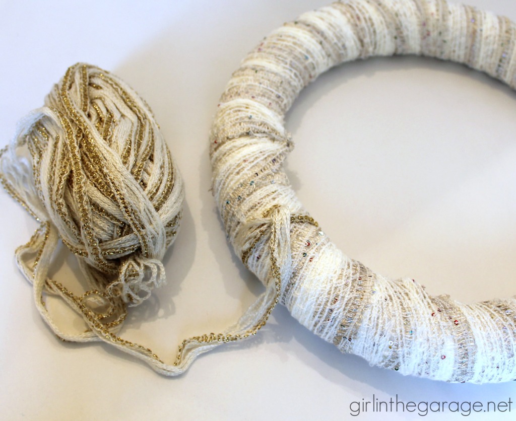 Easy DIY yarn wreath and foyer decorated for Christmas.  girlinthegarage.net