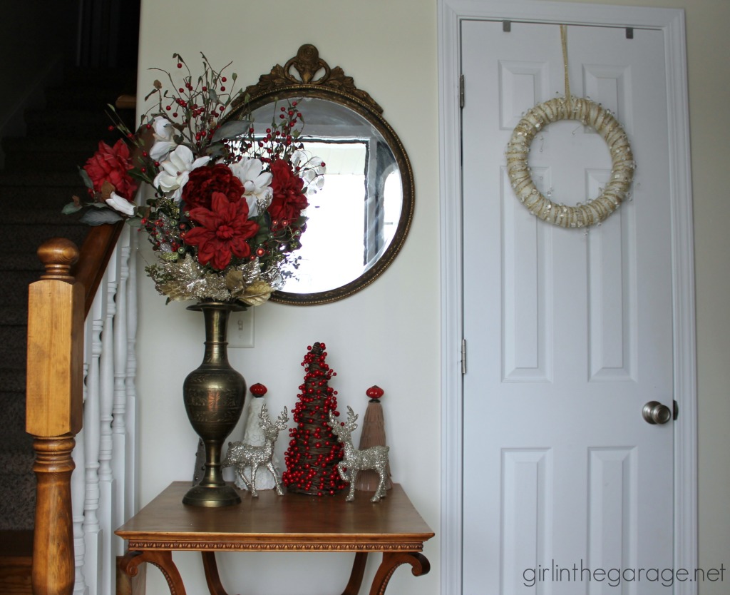 Easy DIY yarn wreath and foyer decorated for Christmas.  girlinthegarage.net