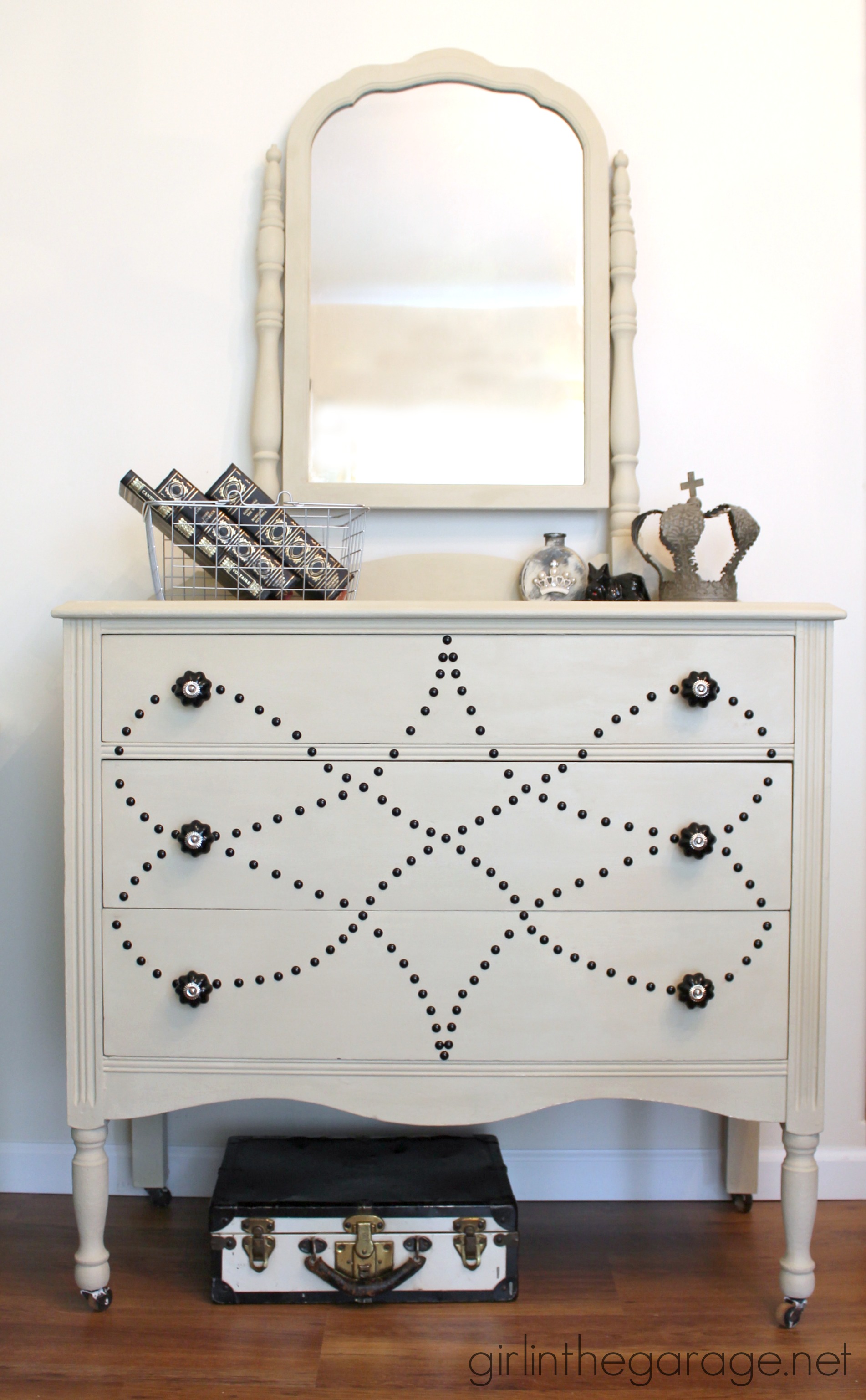 Chalk Painted Vanity Makeover - See how a dated vanity is transformed with Chalk Paint, nailhead trim, and beautiful new knobs. By Girl in the Garage