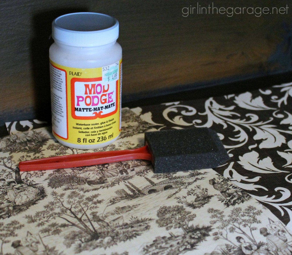 Decoupage Bookcase: How to update a boring bookcase with paint, pretty paper, and Mod Podge. girlinthegarage.net