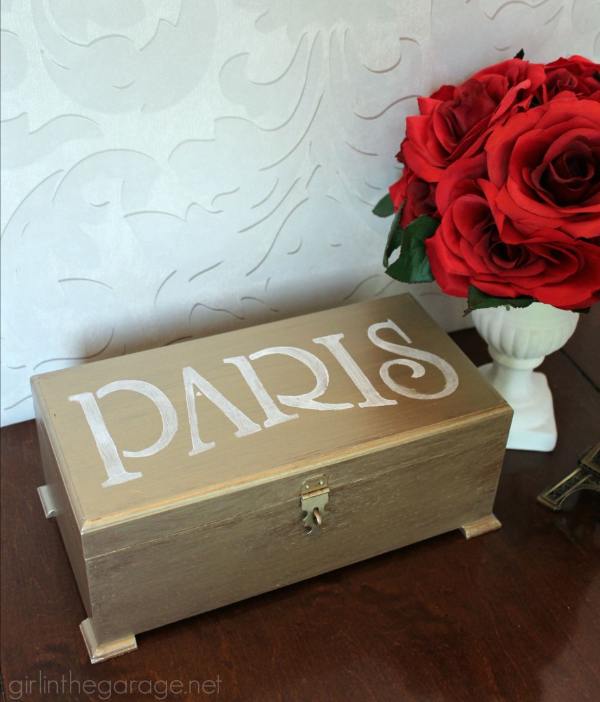 Metallic paint and a Paris stencil glam up a yard sale jewelry box.  girlinthegarage.net