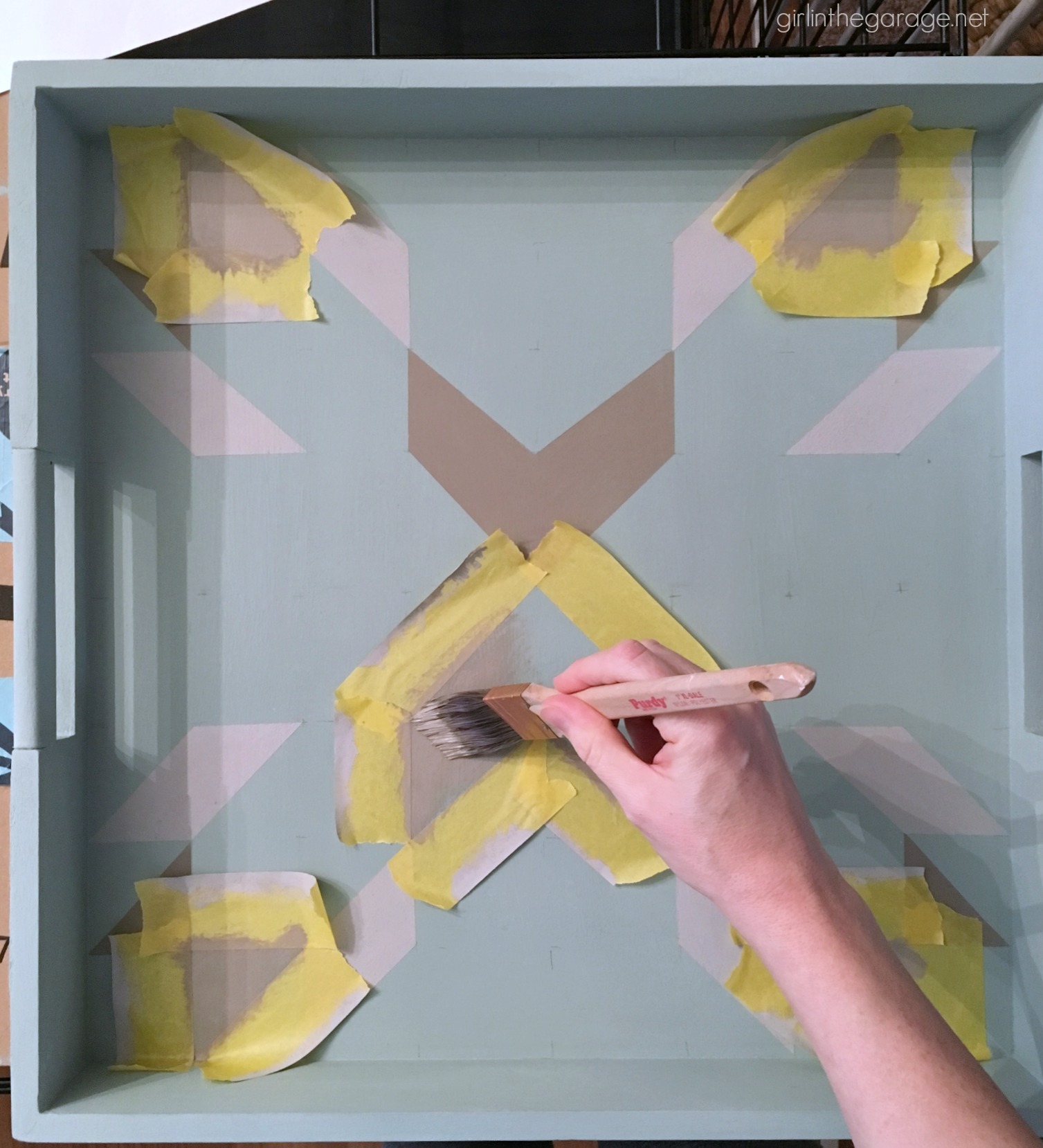 How to paint a barn quilt on a thrifted tray for a beautiful art piece. Step by step DIY tutorial by Girl in the Garage.