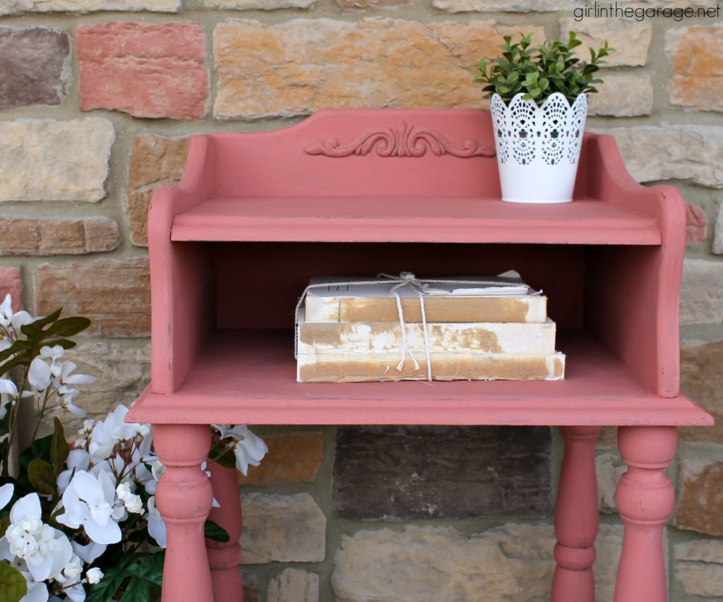 This updated telephone table was rescued from the thrift store and painted pink Chalk Paint. Now it's happy and living its best life. By Girl in the Garage