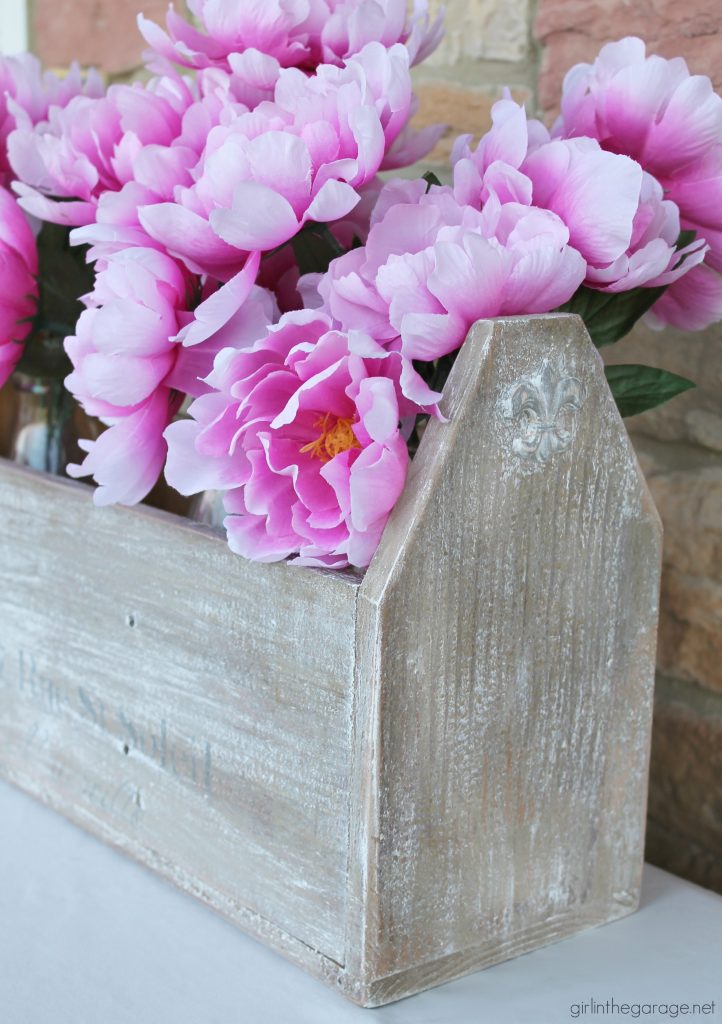 Wooden tote box makeover with a beautiful rustic French vibe - dry brushing, stencil, and wood appliques. DIY tutorial by Girl in the Garage