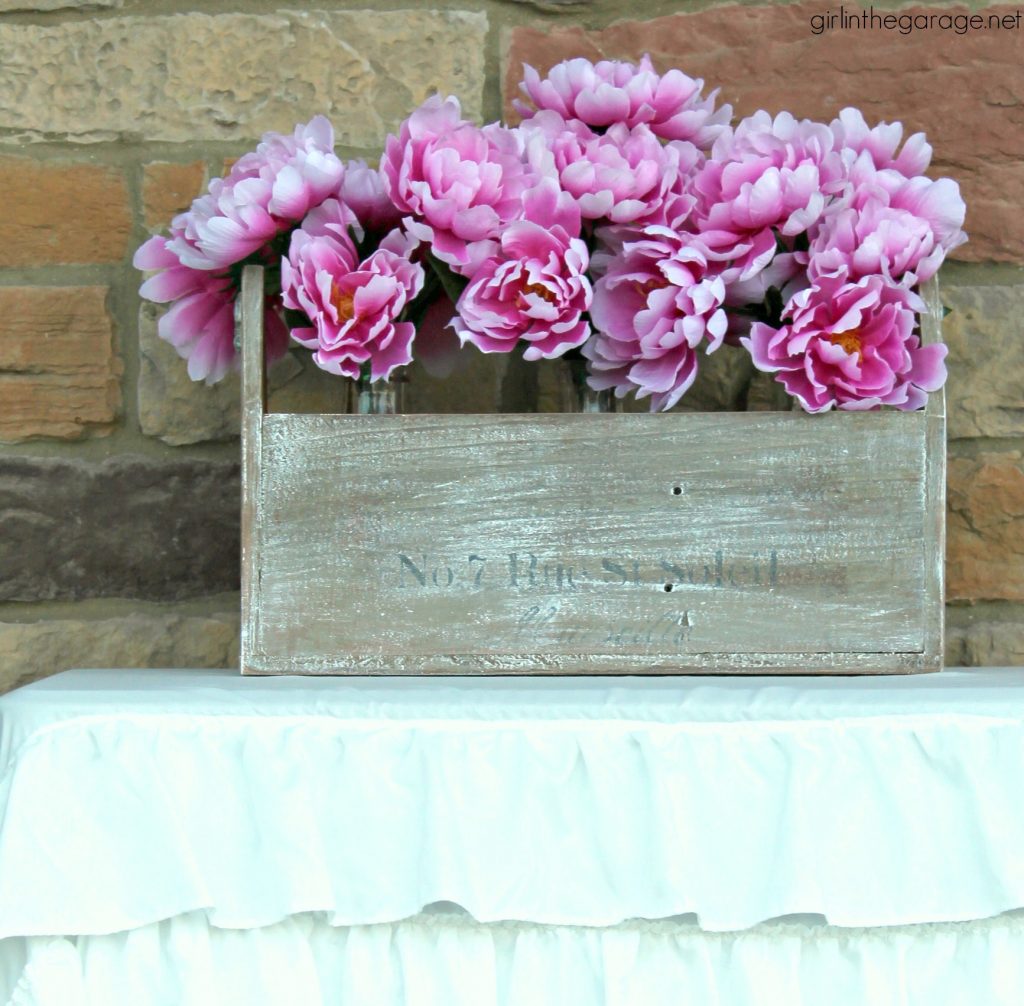 Wooden tote box makeover with a beautiful rustic French vibe - dry brushing, stencil, and wood appliques. DIY tutorial by Girl in the Garage