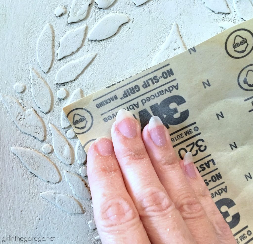 Add amazing custom texture with a raised stencil furniture makeover using spackling from the hardware store. Step by step DIY tutorial for custom embossed furniture by Girl in the Garage.