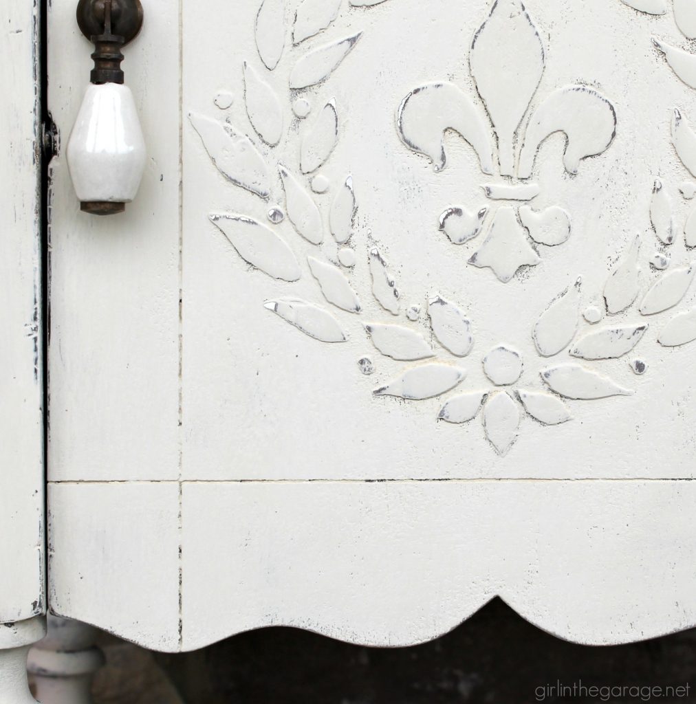 Add amazing custom texture with a raised stencil furniture makeover using spackling from the hardware store. Step by step DIY tutorial for custom embossed furniture by Girl in the Garage.