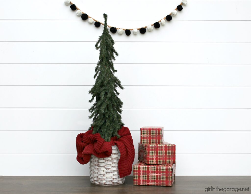 For cozy Christmas decor, learn how to use a thrifted basket as a DIY Christmas tree basket stand. An easy project with beautiful results. DIY furniture makeover and decor ideas by Girl in the Garage
