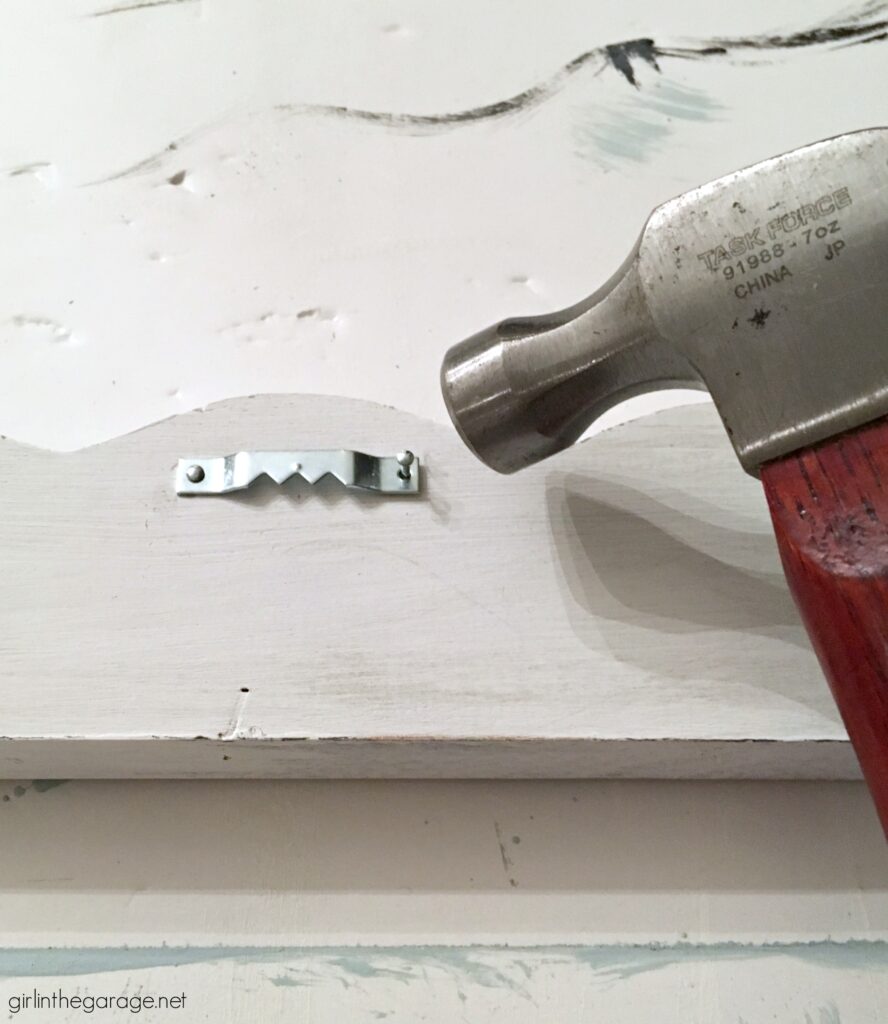 Nail sawtooth hanger on back - Girl in the Garage