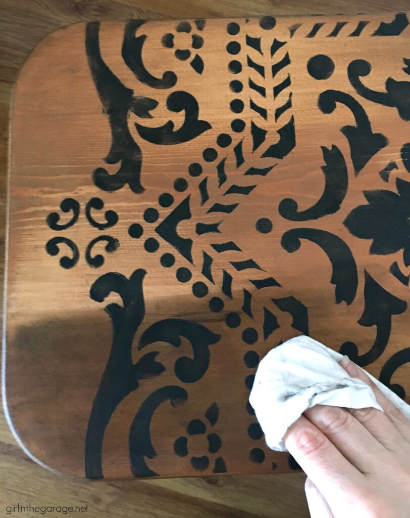 Love the black wood stain look? Learn how to stencil a table and easily stain wood black with furniture wax. By Girl in the Garage