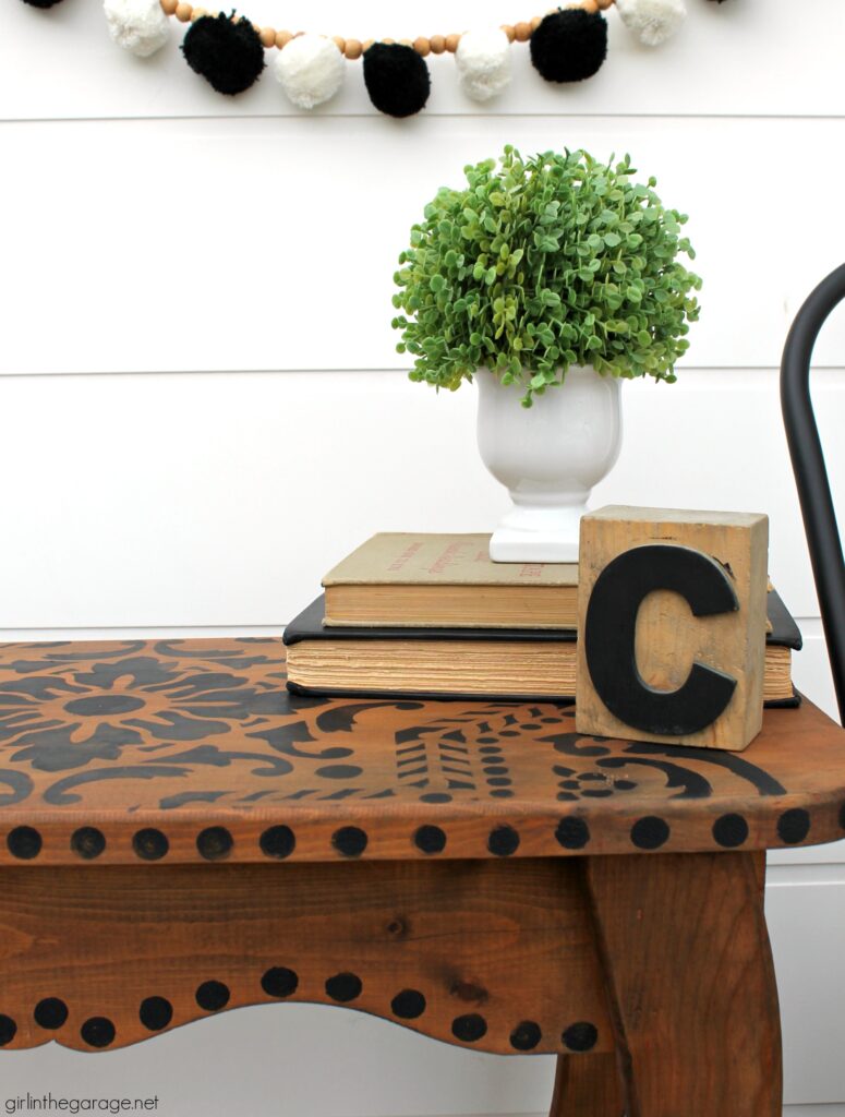 Love the black wood stain look? Learn how to stencil a table and easily stain wood black with furniture wax. By Girl in the Garage