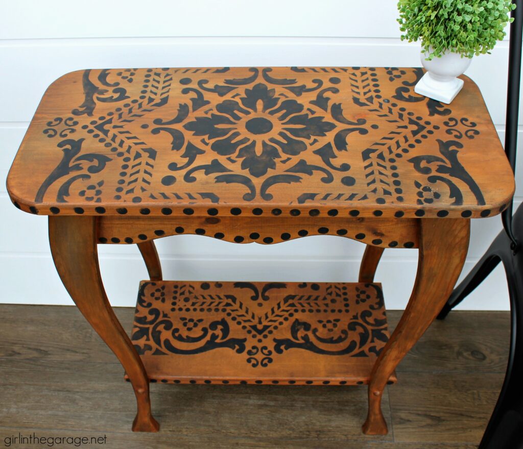 Love the black wood stain look? Learn how to stencil a table and easily stain wood black with furniture wax. By Girl in the Garage