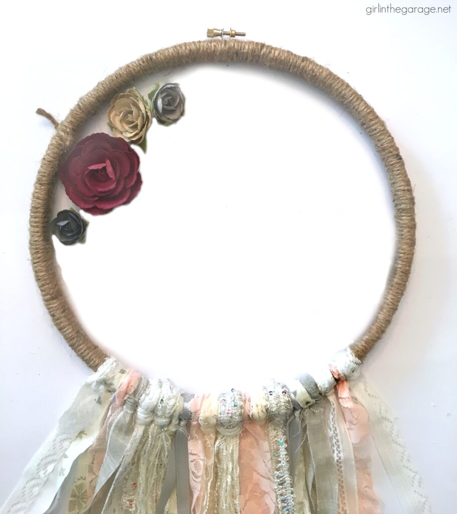 Make a stunning DIY embroidery hoop wreath with fabric scraps. Add some flowers for fun! DIY decor ideas by Girl in the Garage