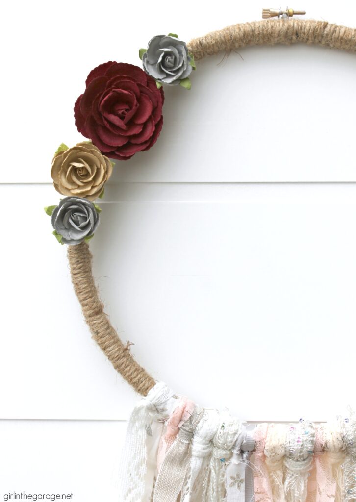 Huge fabric stash? Use your fabric scraps along with ribbon and lace to make a stunning DIY embroidery hoop wreath. Add some flowers for fun! DIY decor ideas by Girl in the Garage