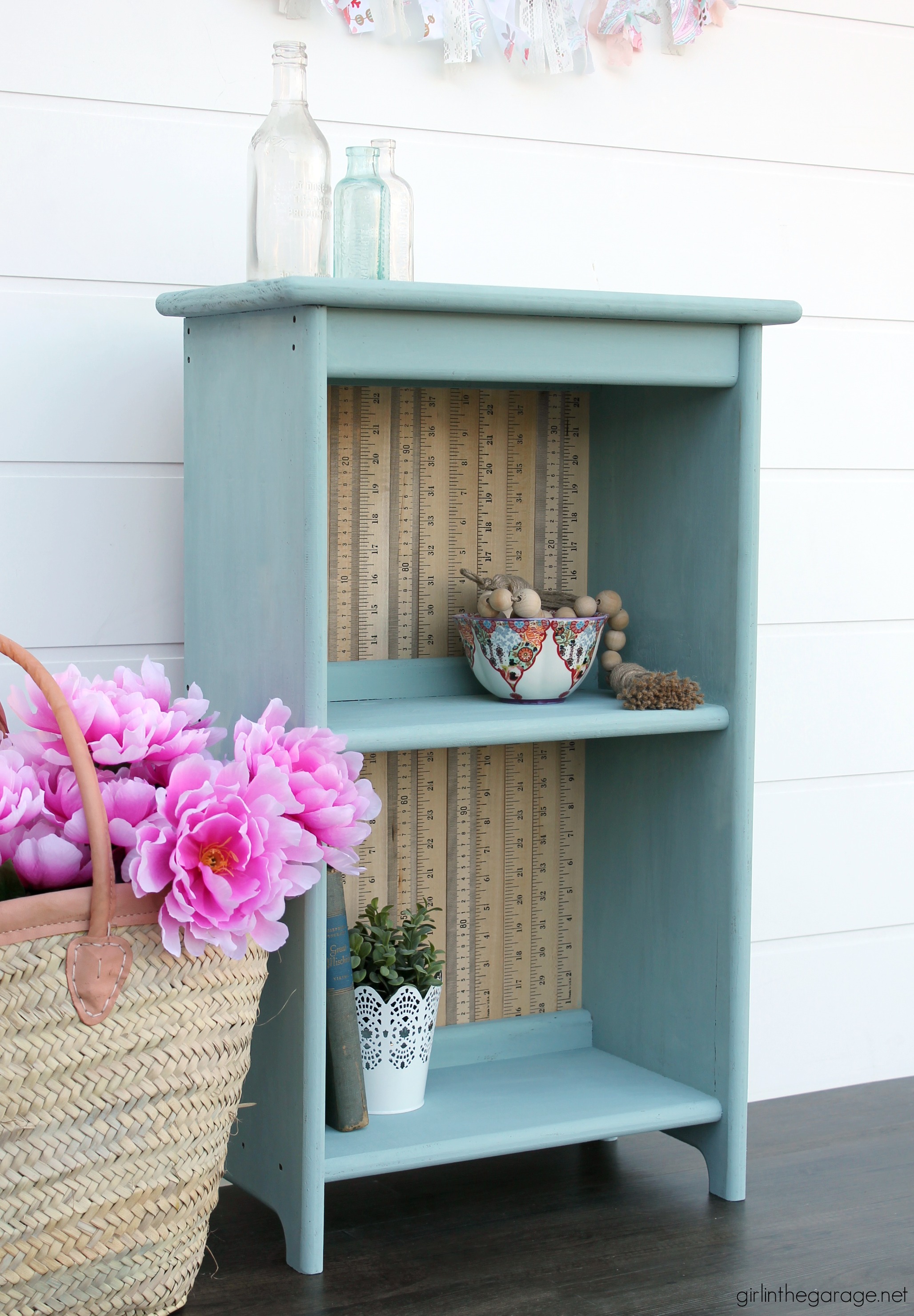 Give an old bookcase pizzazz with Chalk Paint and repurposed yardsticks. This easy painted furniture makeover idea oozes vintage charm. By Girl in the Garage