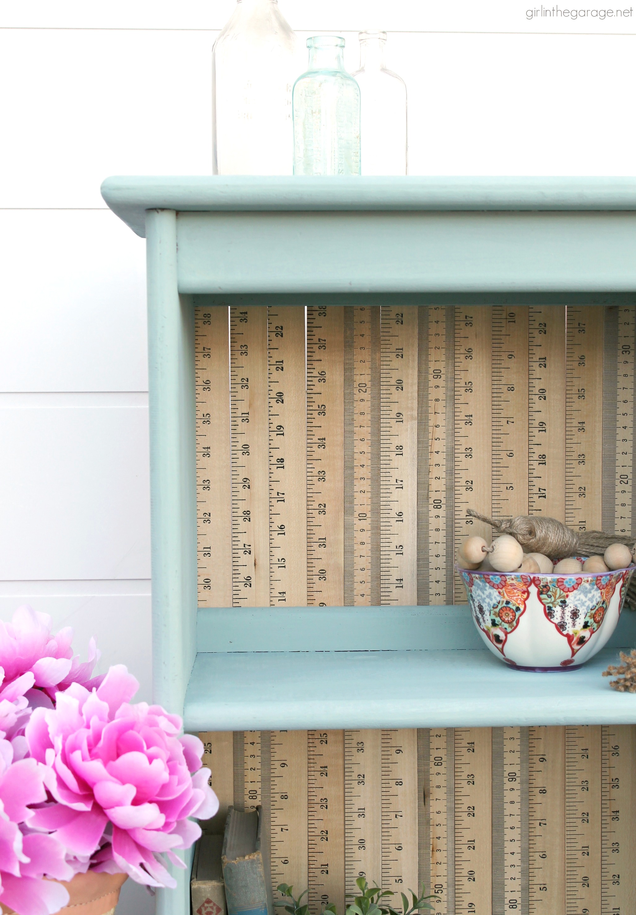 Give an old bookcase pizzazz with Chalk Paint and repurposed yardsticks. This easy painted furniture makeover idea oozes vintage charm. By Girl in the Garage