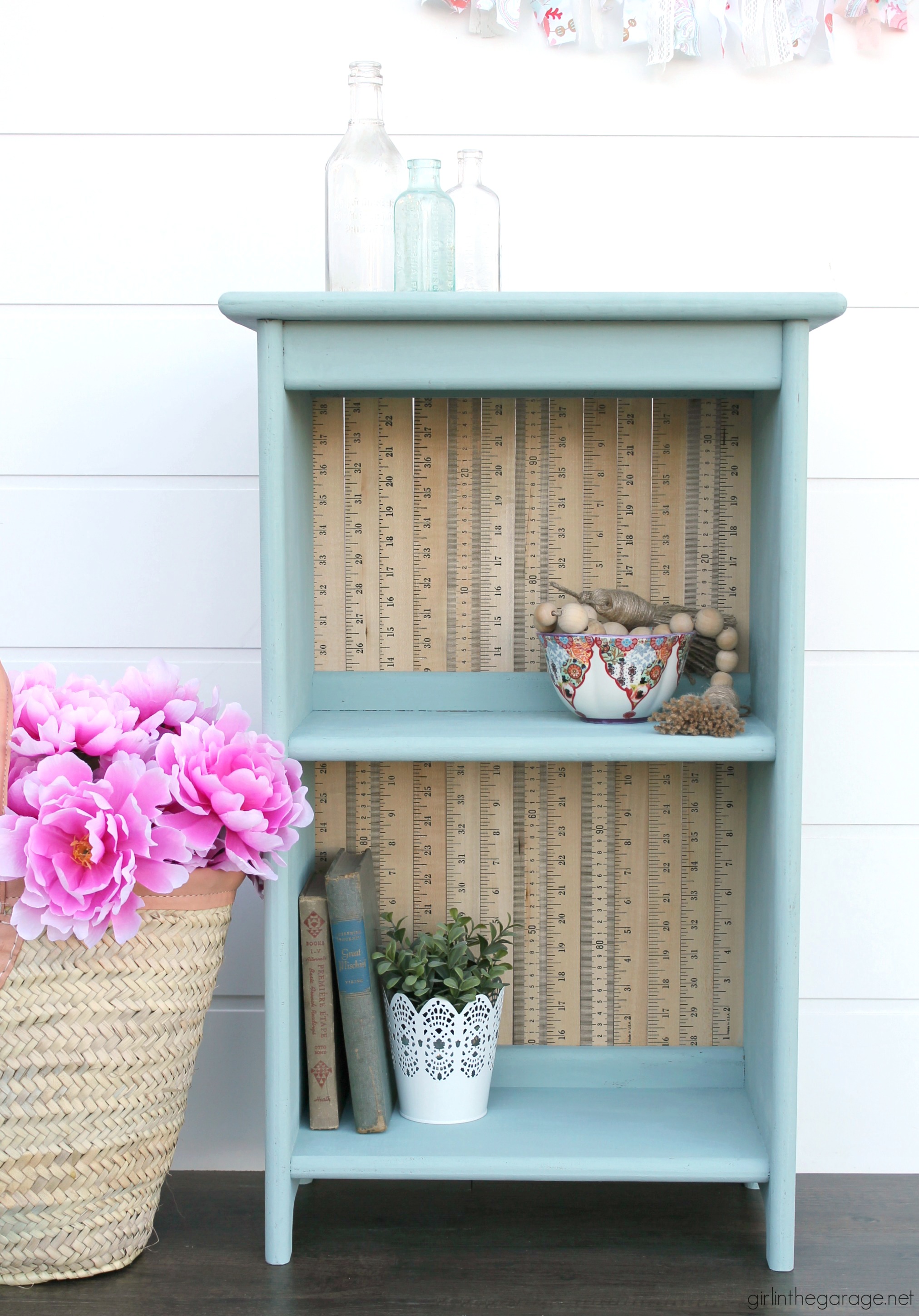 Give an old bookcase pizzazz with Chalk Paint and repurposed yardsticks. This easy painted furniture makeover idea oozes vintage charm. By Girl in the Garage