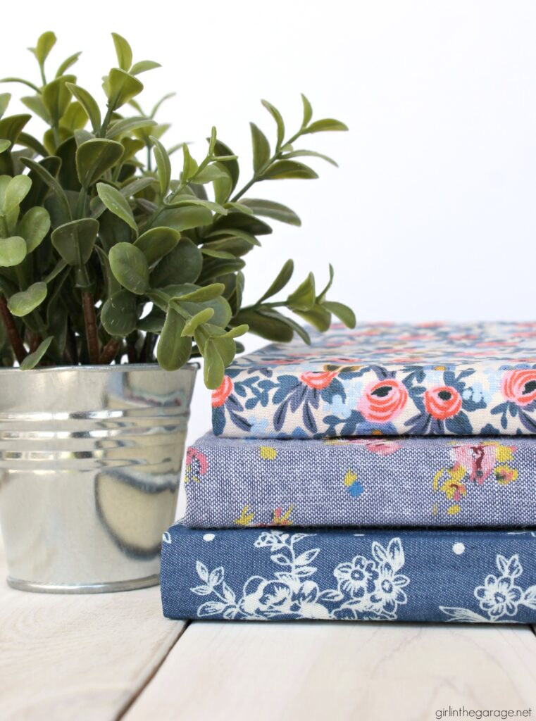 Learn how to decoupage fabric onto books and create gorgeous budget-friendly DIY home decor with this step by step tutorial from Girl in the Garage.