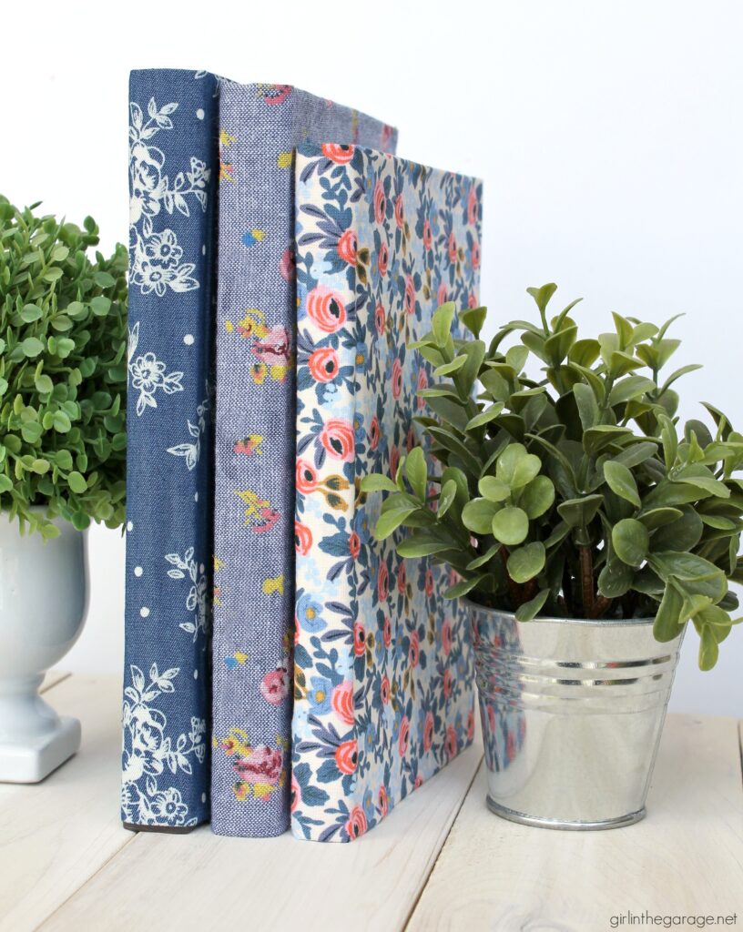 Learn how to decoupage fabric onto books and create gorgeous budget-friendly DIY home decor with this step by step tutorial from Girl in the Garage.