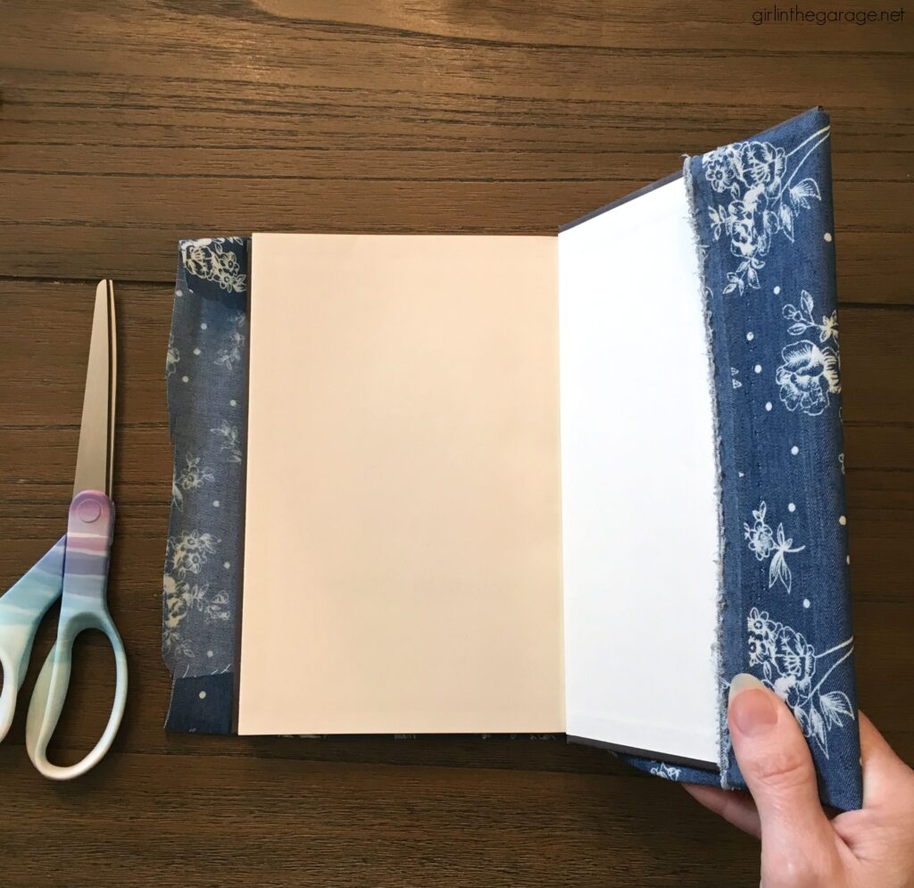 Learn how to decoupage fabric onto books and create gorgeous budget-friendly DIY home decor with this step by step tutorial from Girl in the Garage.