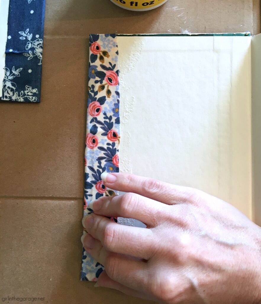 Learn how to decoupage fabric onto books and create gorgeous budget-friendly DIY home decor with this step by step tutorial from Girl in the Garage.