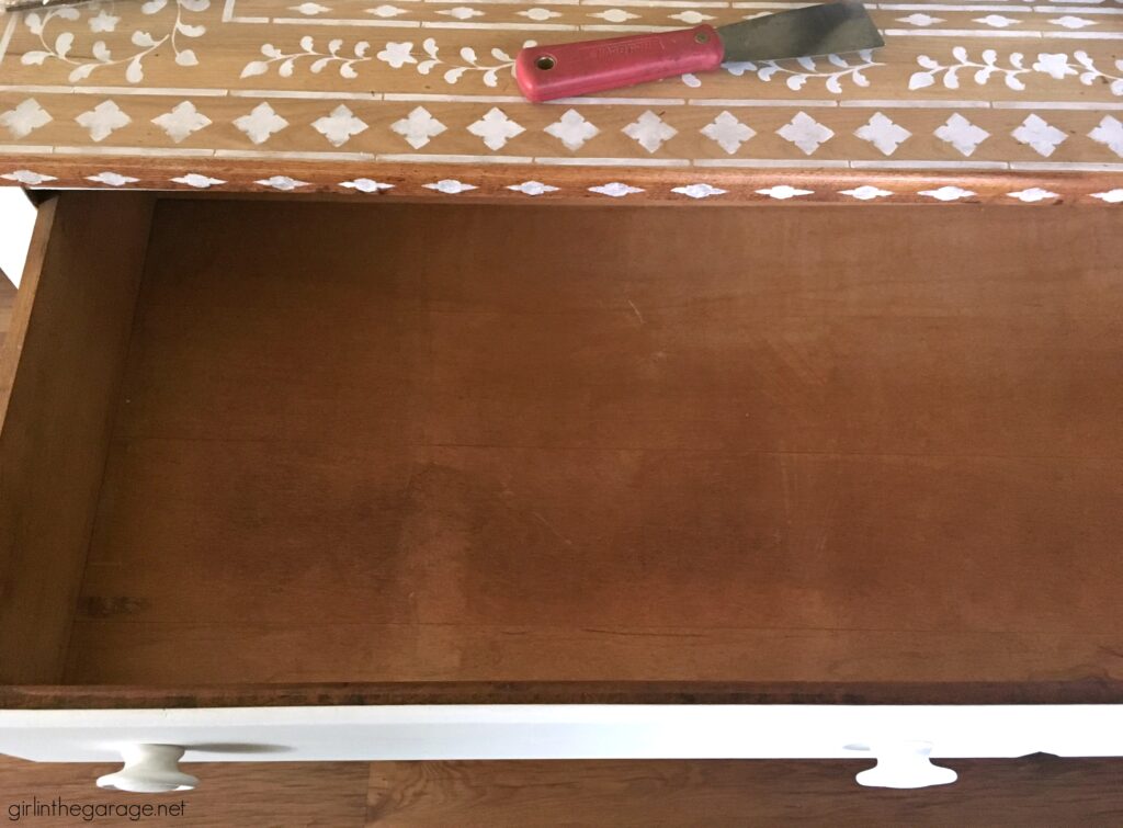 Do your drawers have old contact paper stuck inside? Discover how to remove contact paper the easy way. DIY painted furniture ideas by Girl in the Garage