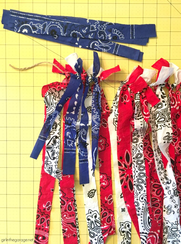 Make this festive DIY rag flag with bandanas for your 4th of July decor. Celebrate the summer with amazing DIY patriotic home decor ideas. By Girl in the Garage