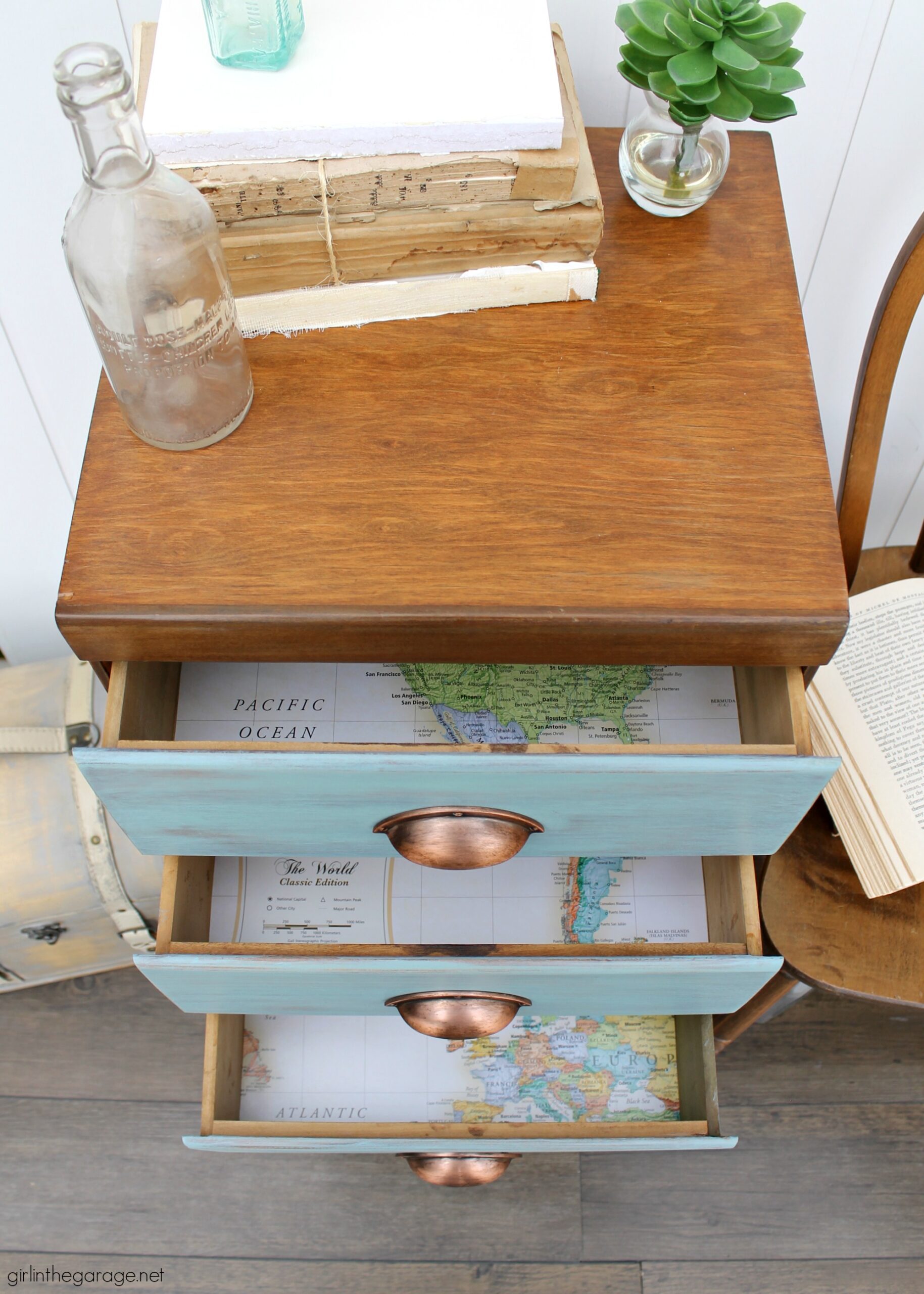 Learn how to refinish a dresser with Minwax products including Vintage Blue, the 2021 Color of the Year. Add faux-aged copper pulls and map paper lined drawers for the finishing touch. #ad DIY makeover ideas by Girl in the Garage