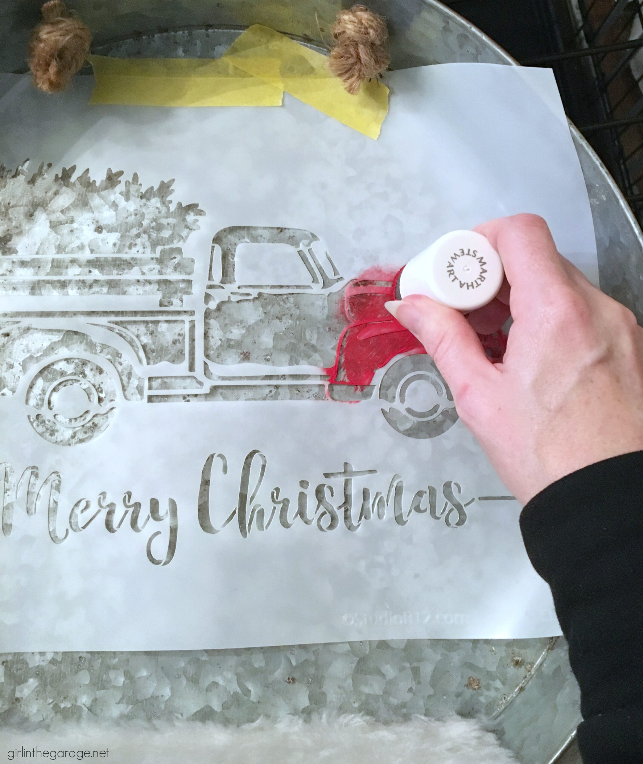 Make a DIY Christmas wreath from a repurposed metal tray - an adorable Christmas decor idea with stenciled truck and miniature bottle brush trees! By Girl in the Garage