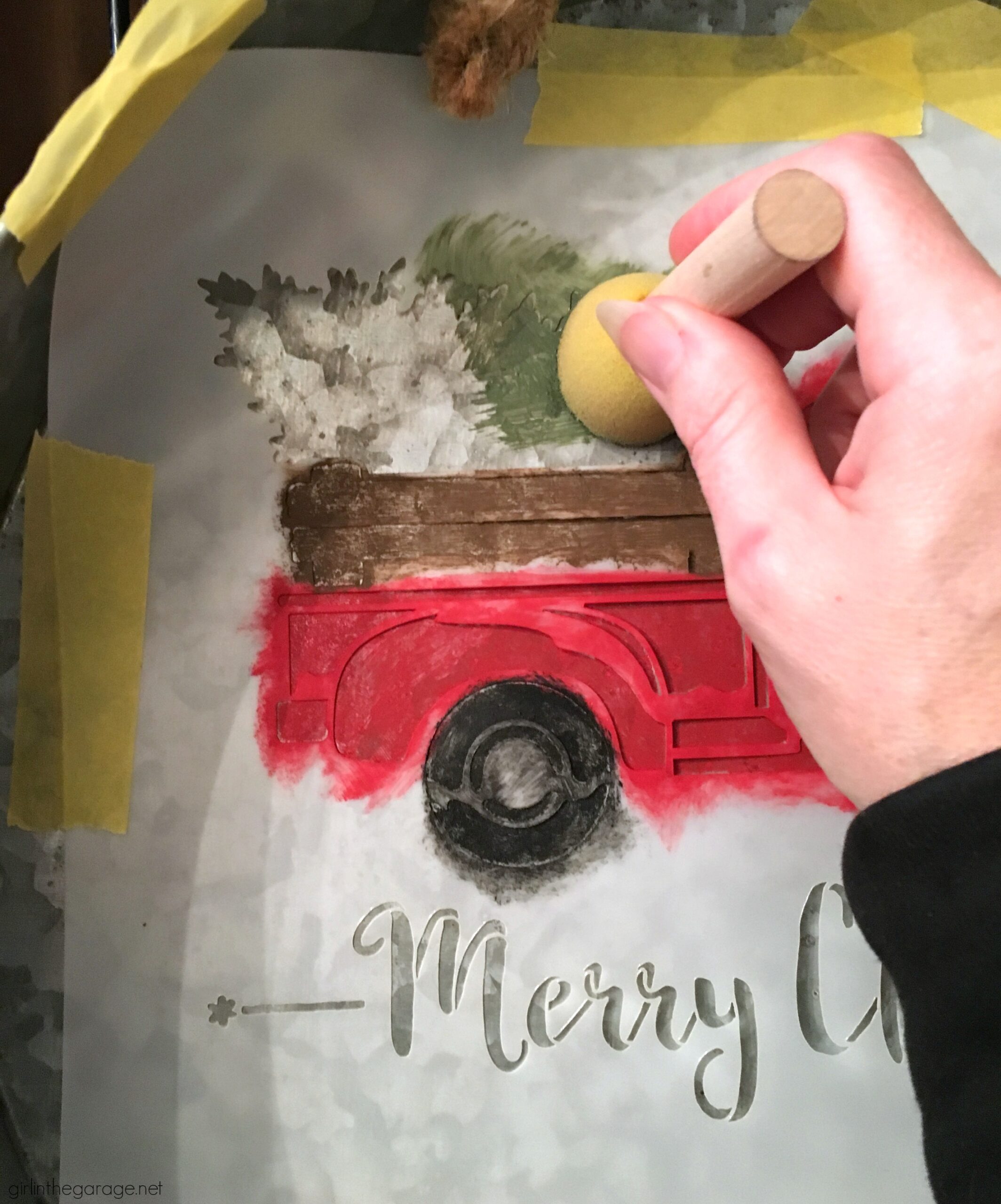 Make a DIY Christmas wreath from a repurposed metal tray - an adorable Christmas decor idea with stenciled truck and miniature bottle brush trees! By Girl in the Garage