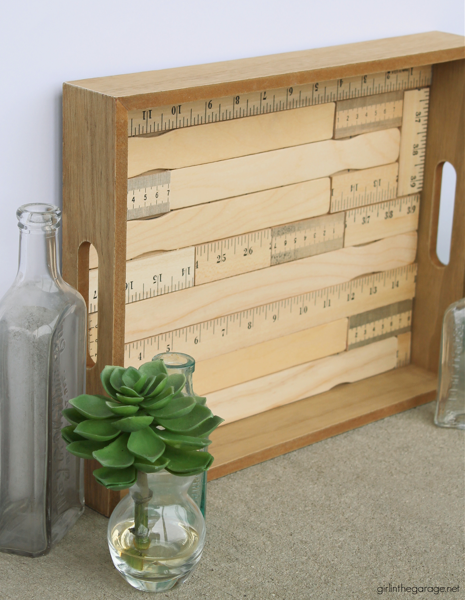 How to make an adorable upcycled wood tray with yardsticks and paint stirrers. Easy DIY home decor idea by Girl in the Garage