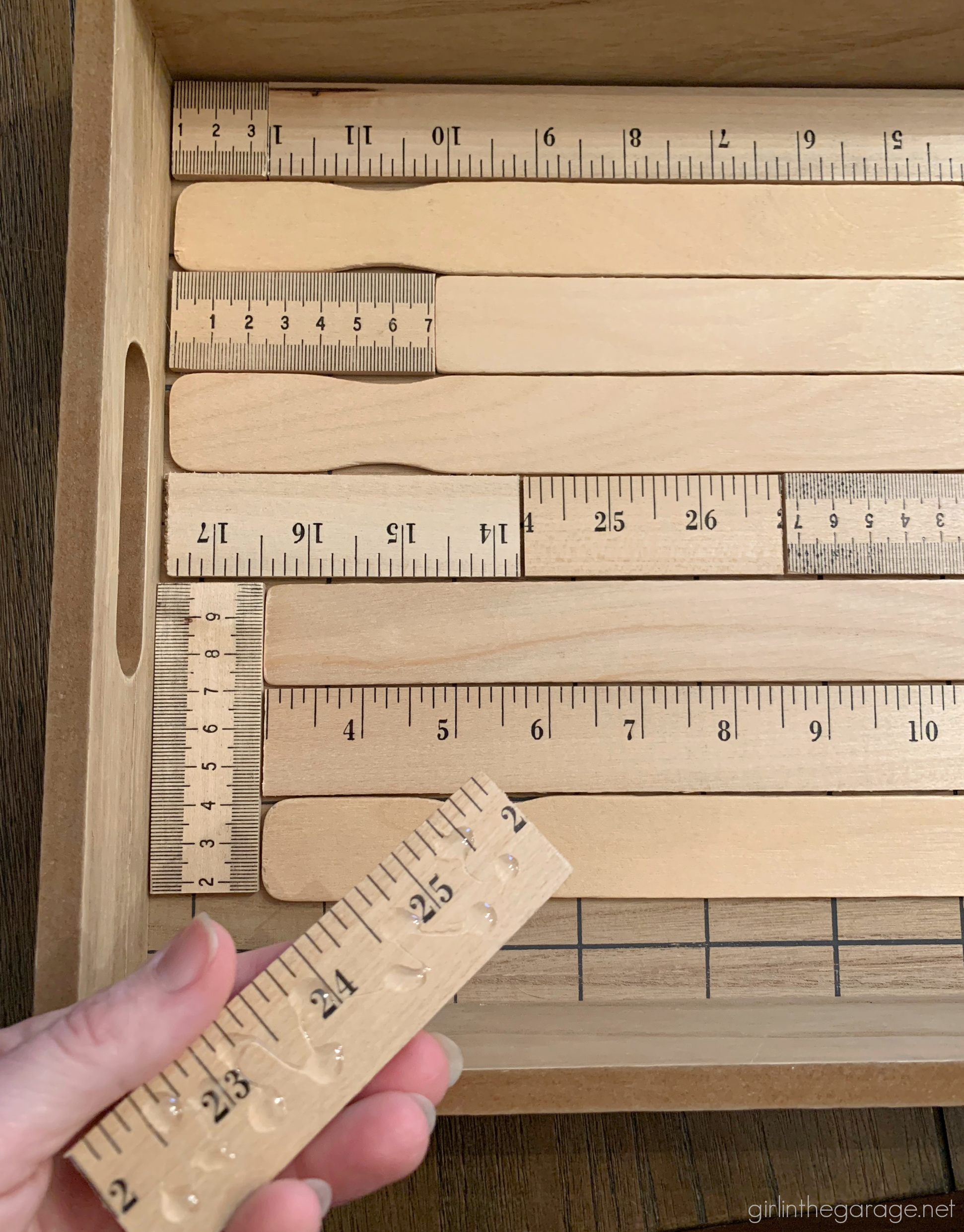 How to make an adorable upcycled wood tray with yardsticks and paint stirrers. Easy DIY home decor idea by Girl in the Garage