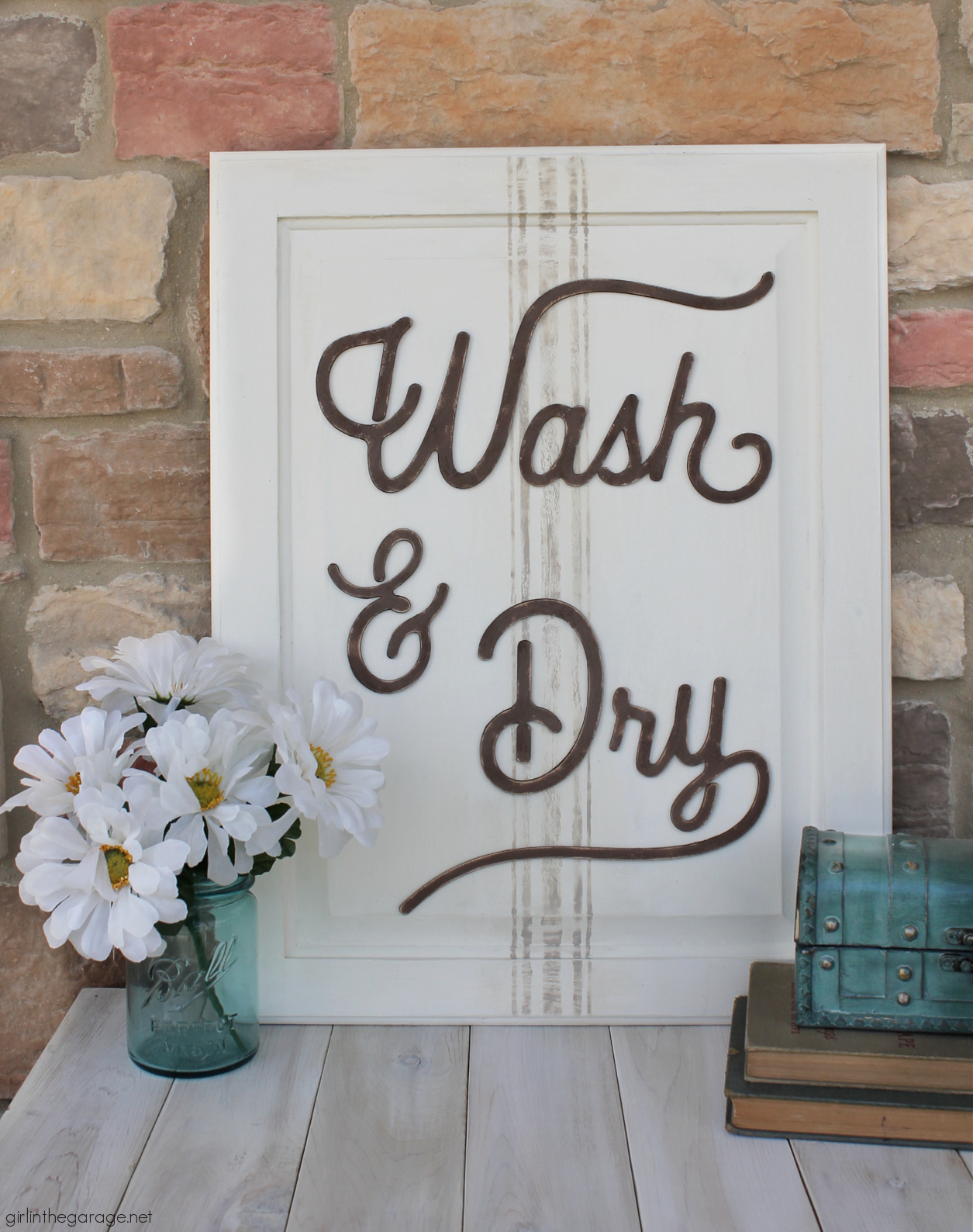 Have an old cabinet door? Learn how to repurpose it into an adorable DIY laundry room sign with grain sack stripes! By Girl in the Garage