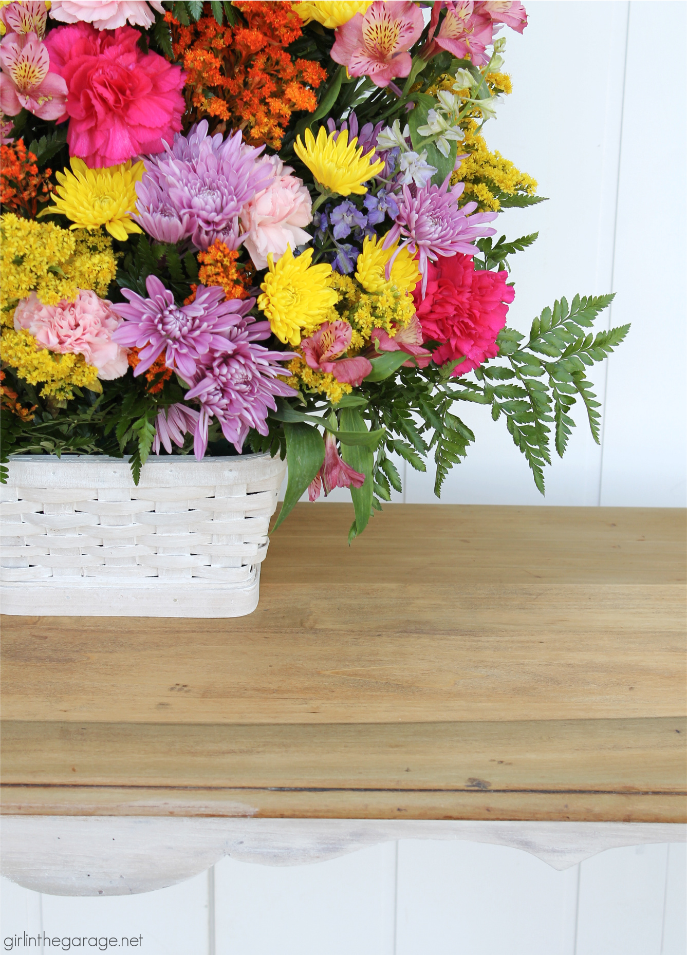 Learn how to create a DIY farmhouse sofa table with just a hint of whitewashed paint on bottom and a gorgeous natural wood top. DIY painted furniture and decor ideas by Girl in the Garage