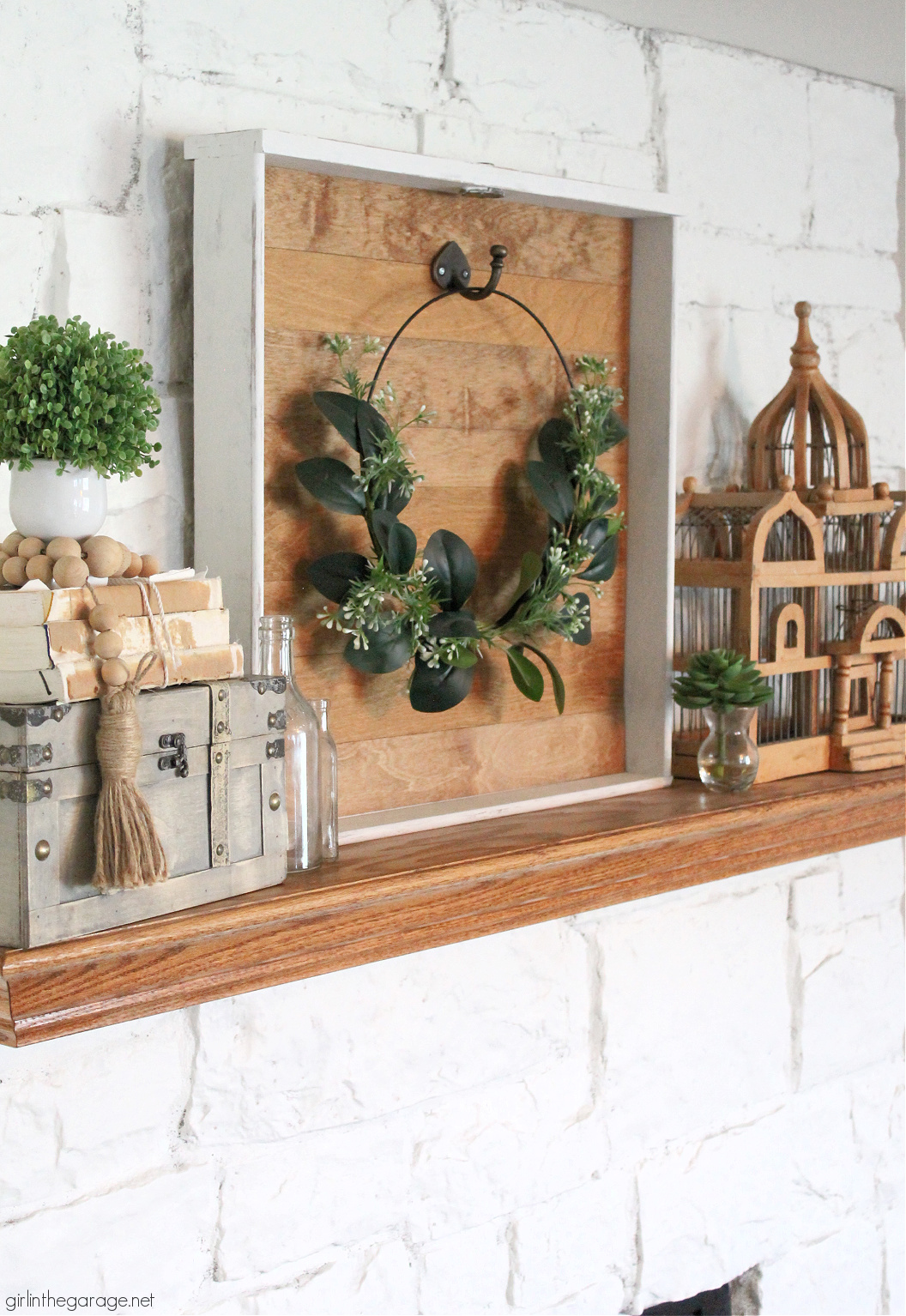 How to make a DIY wreath hanger from a repurposed drawer. Easily hang your wreaths on your mantel with this tutorial by Girl in the Garage