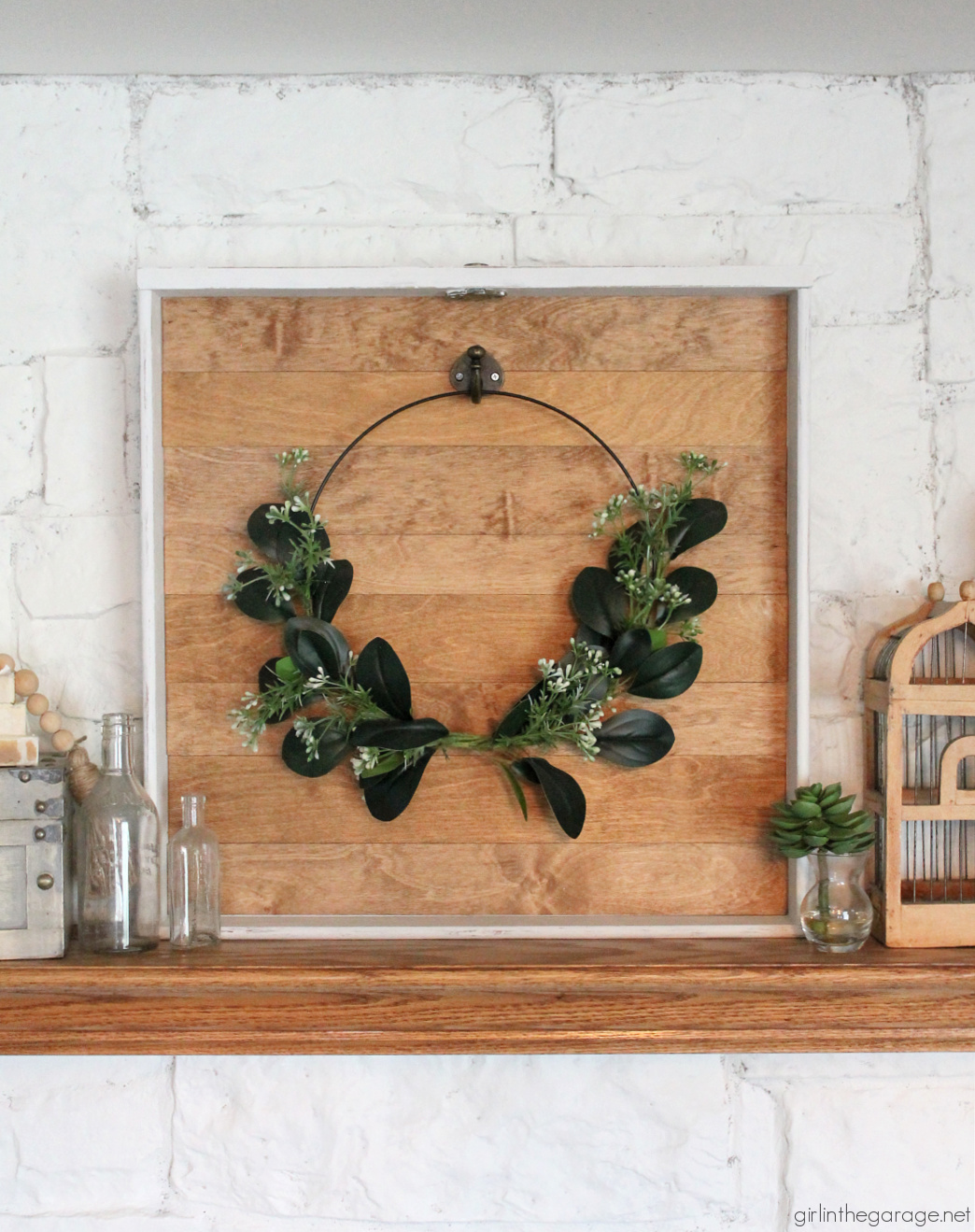 How to make a DIY wreath hanger from a repurposed drawer. Easily hang your wreaths on your mantel with this tutorial by Girl in the Garage