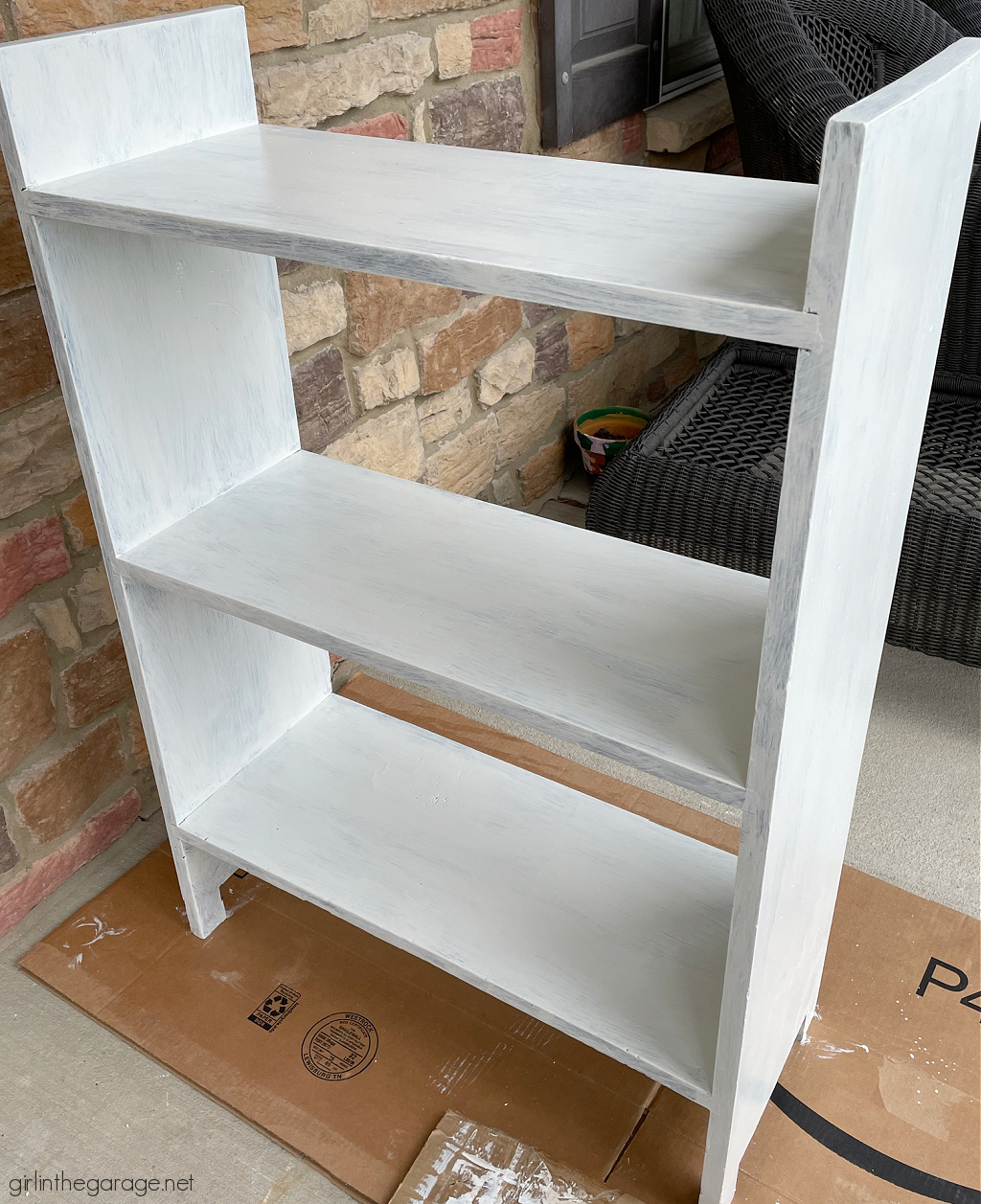 How to paint a bookcase white and add a whimsical stencil in multiple Country Chic Paint colors for a fun and unique furniture idea. By Girl in the Garage