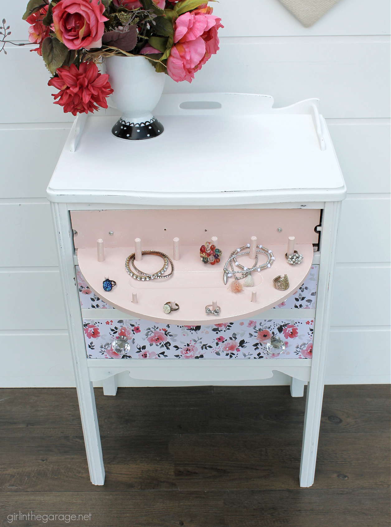 Secret jewelry drawer! How to paint a vintage nightstand white and add charming decoupage poster board on the drawers. By Girl in the Garage