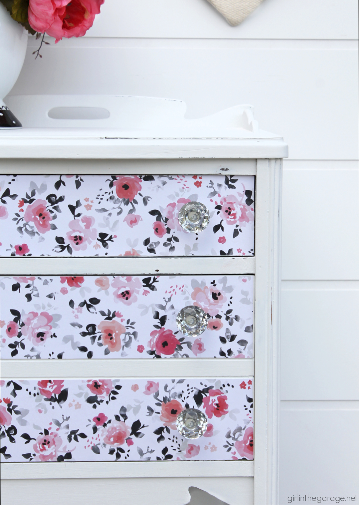 How to paint a vintage nightstand white and add charming decoupage poster board on the drawers. By Girl in the Garage