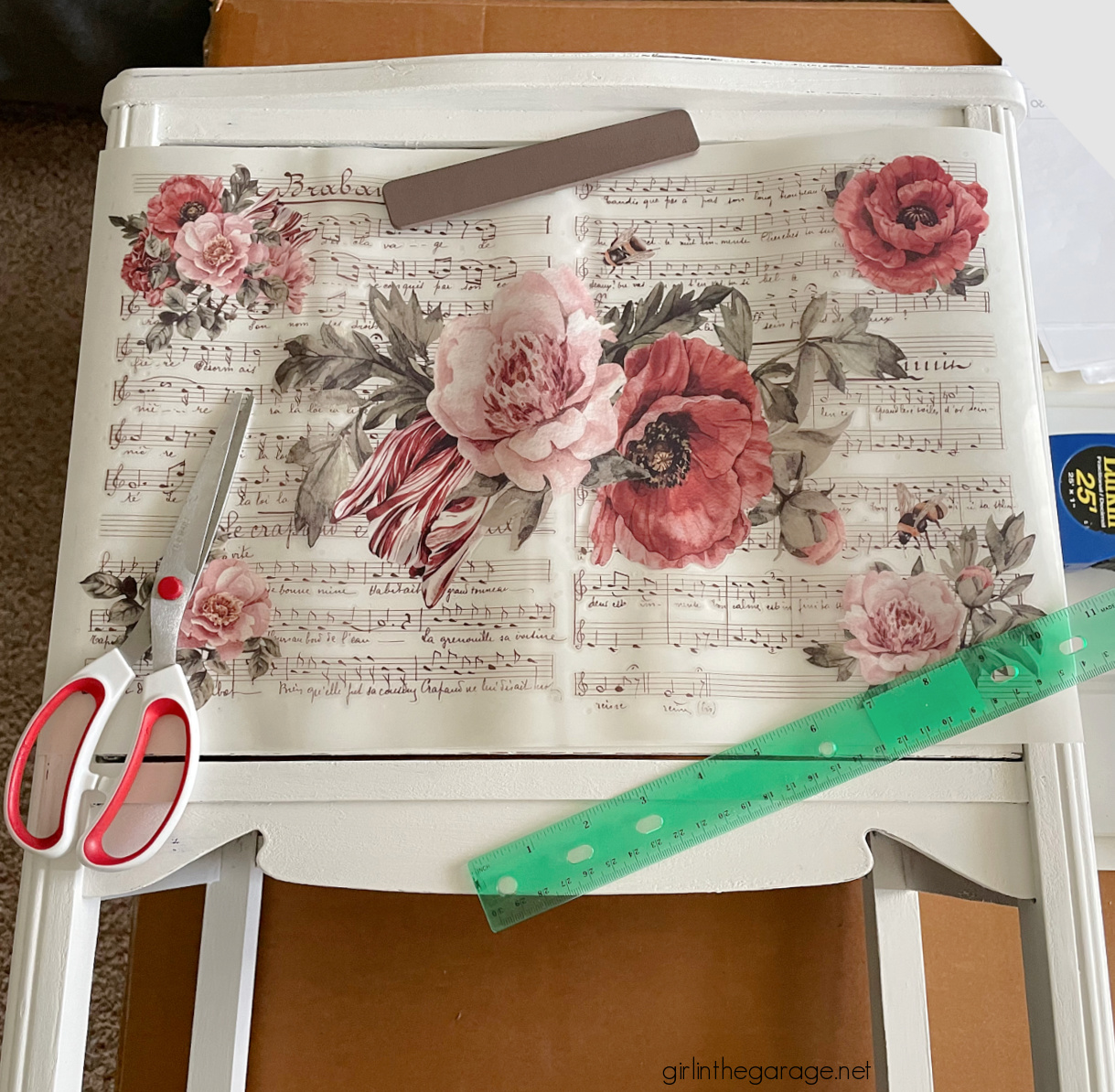 How to paint a vintage nightstand white and add charming decoupage poster board on the drawers. By Girl in the Garage