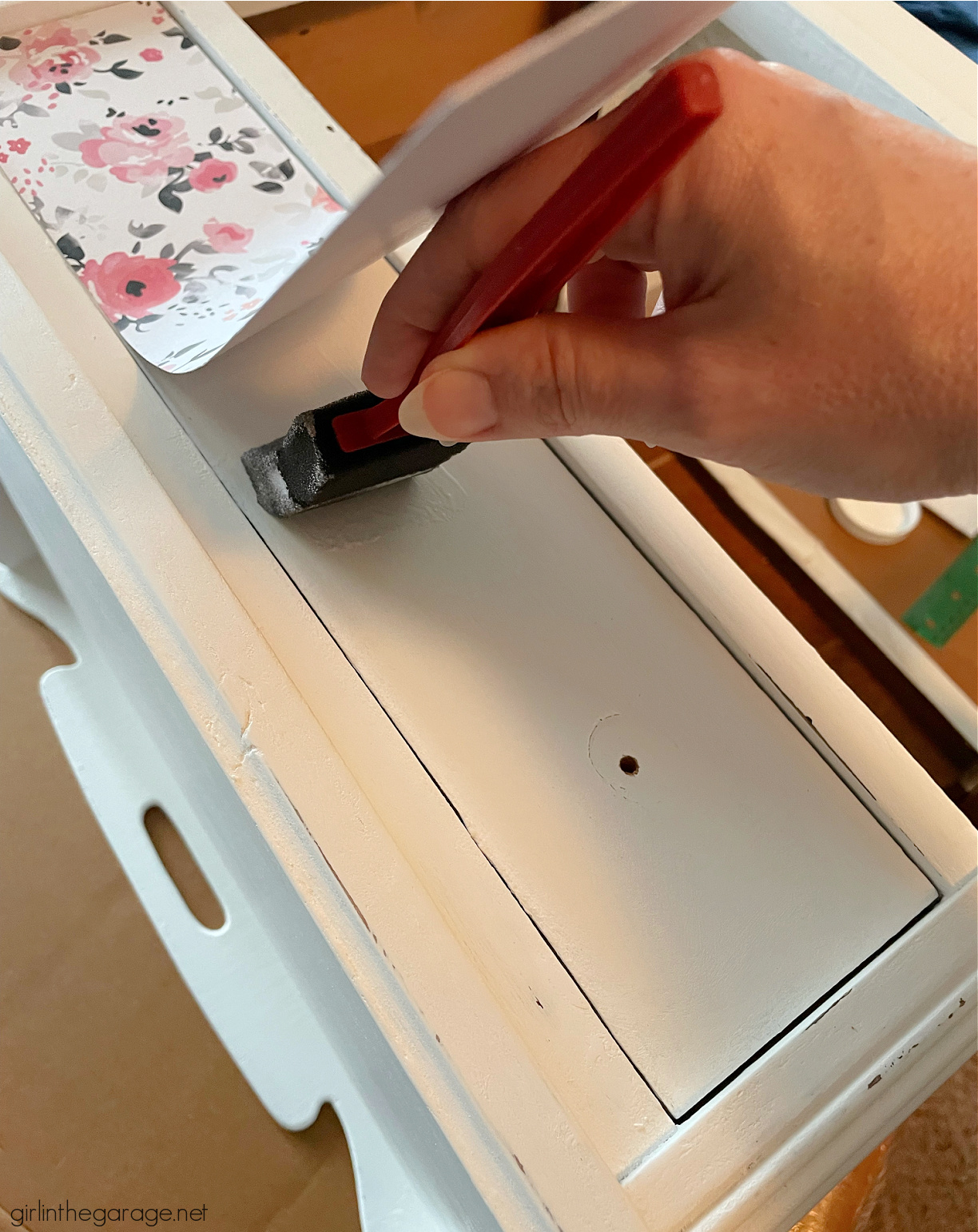 How to paint a vintage nightstand white and add charming decoupage poster board on the drawers. By Girl in the Garage