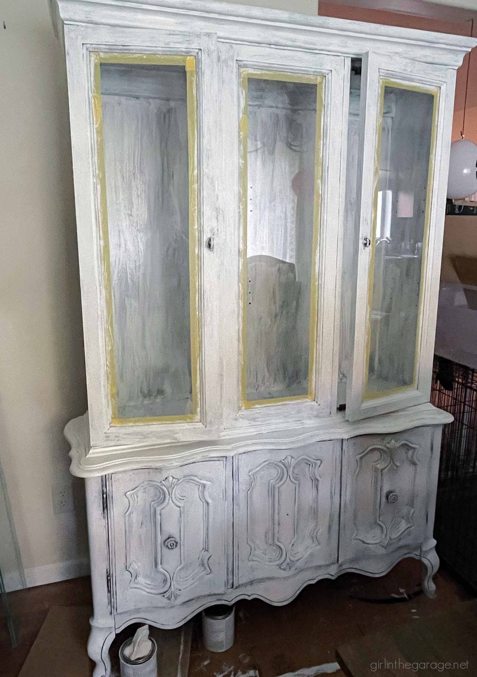 How to create a gorgeous painted china cabinet with wallpapered back. Full tutorial with photos by Girl in the Garage.