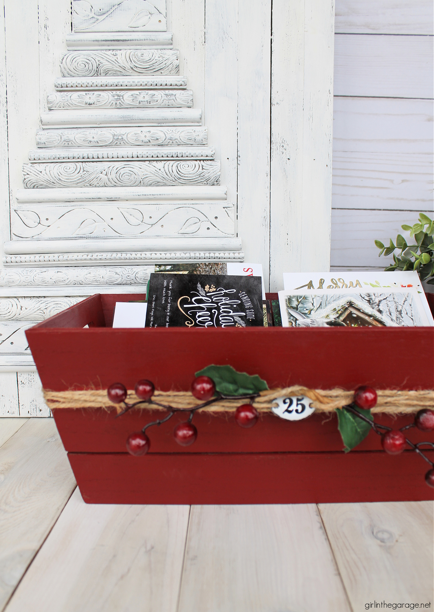 Learn how to transform a plain Target wood crate into a festive DIY Christmas card holder box with just a few supplies. Super cute Christmas decor idea by Girl in the Garage