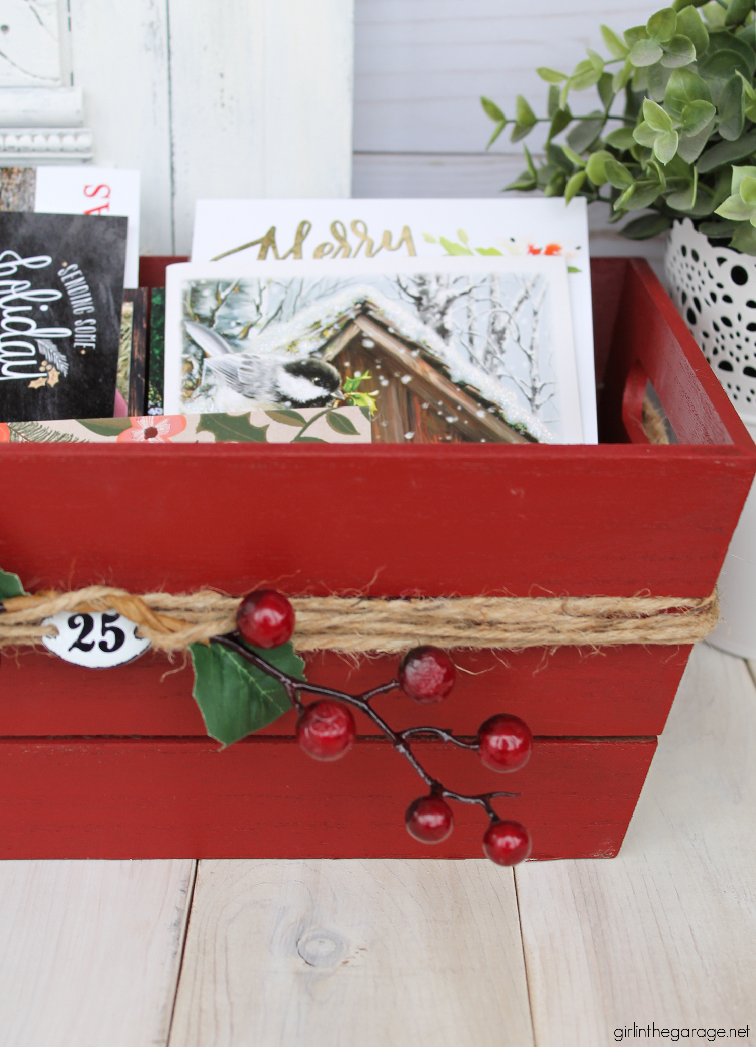 Learn how to transform a plain Target wood crate into a festive DIY Christmas card holder box with just a few supplies. Super cute Christmas decor idea by Girl in the Garage