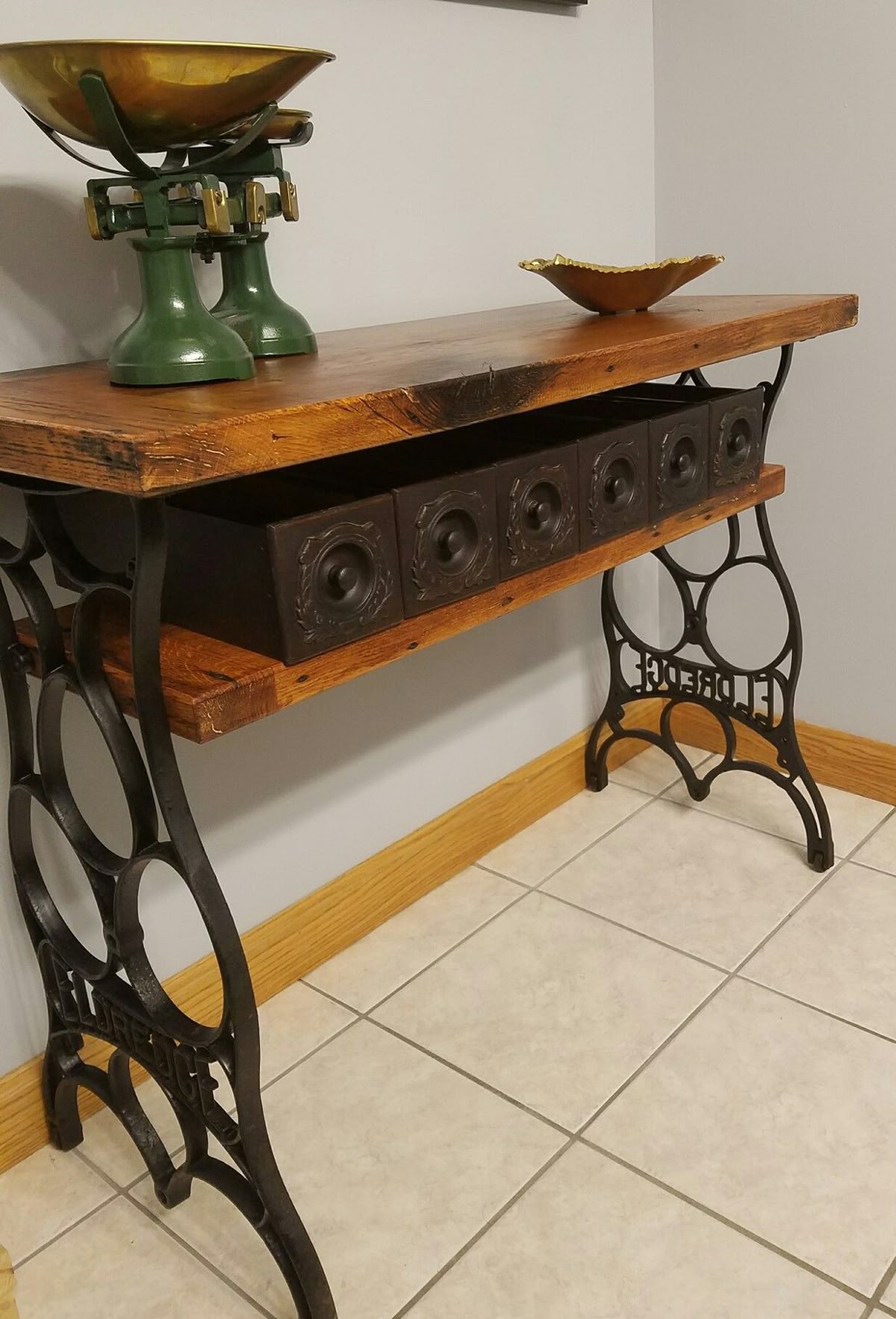 Sewing machine table repurposed to side table with rustic wood shelves
