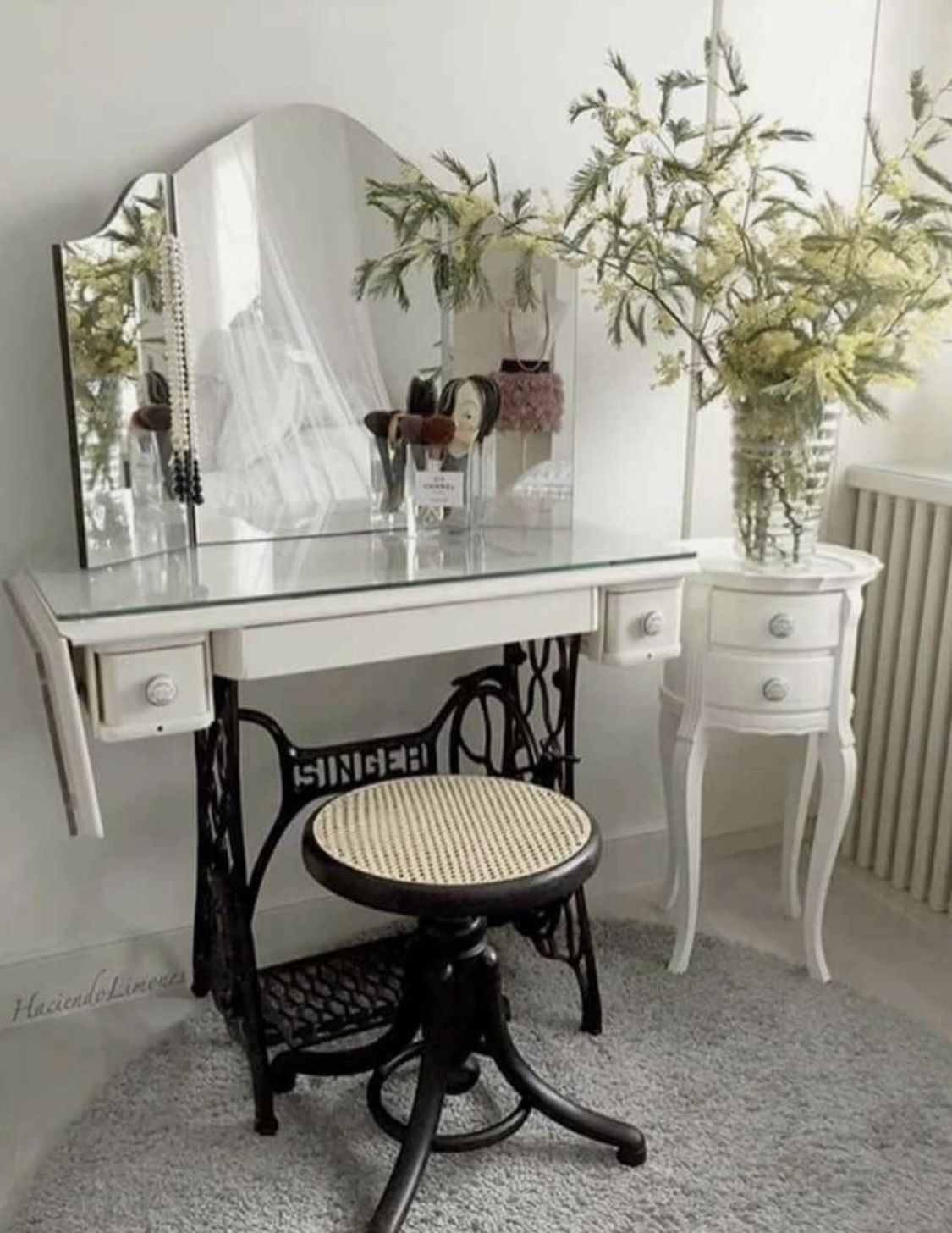 Antique Singer sewing machine table upcycled into a vanity with mirror and glass top